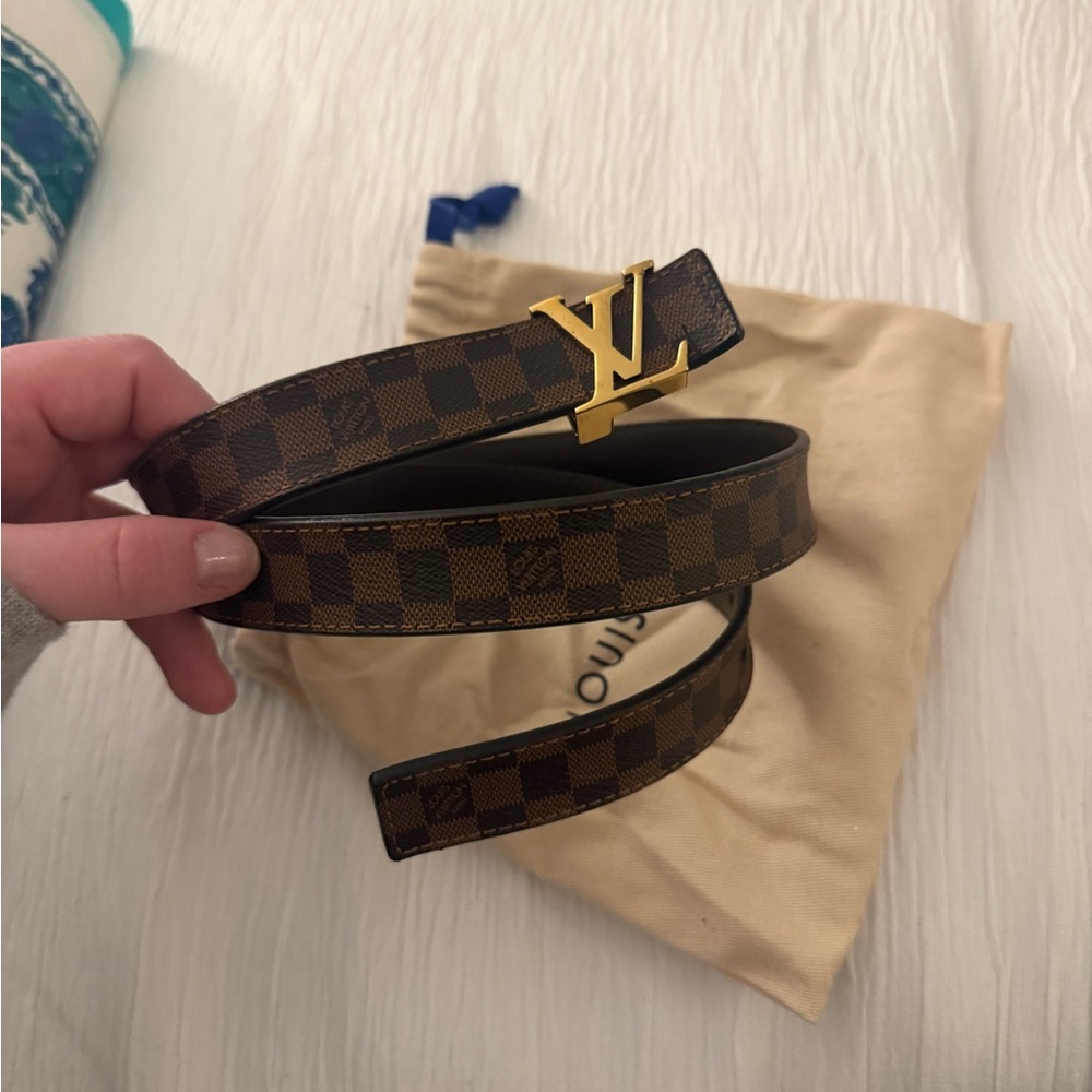 Louis Vuitton Belt with Gold LV Buckle. Fits a pant size small.
